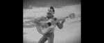 Playing the guitar with a wink in one of his footages