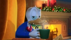 Donald sentado en su silla, bebiendo chocolate caliente