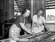 Mary Costa discussing the background paintings with Witmer.