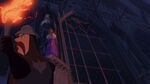 ...and doesn't notice Esmeralda, who is escaping the cathedral with Quasimodo's help.