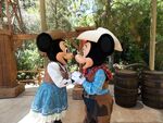 Mickey and Minnie rub their noses together at Disneyland.