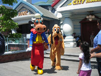 Clarabelle with Pluto at one of the Disney Parks