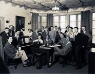 Standing from left: Edmond Seward, Frank Churchill, Otto Englander, Sharpsteen, Bert Lewis, Gilles "Frenchy" de Tremaudan, Clark, Rudy Zamora, Jackson, King, Tom Palmer, Jack Cutting (behind Palmer), Cannon, Ferguson, Smith Seated, from left: David Hand, Ted Sears, Lundy, Gillett, W. Disney