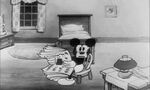 Mickey reading paper nervously