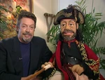 Tim Curry with his caricature behind the scenes of Muppet Treasure Island.