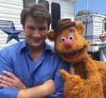 Fillion with Fozzie Bear in The Muppets.