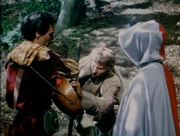 Midge paying Allan-a-Dale to hear him sing a song about Robin Hood again