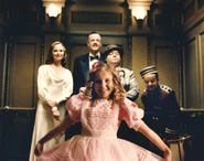 Sally does a curtsy in front of reporters.