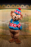 Duffy the Disney Bear posing for a photo inside the Cape Cod Village Greeting Place at Tokyo DisneySea in his Home Sweet Christmas outfit.