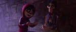 Héctor paints Miguel to disguise him as a skeleton