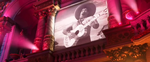 One of the footages of the same guitar played on the wall