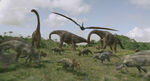 Four adult Parasaurolophus grazing along with two Iguanodon, several Pachyrhinosaurus, and three Brachiosaurus