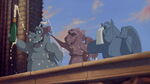 The Gargoyles celebrate with victory as Quasi is praised as a hero.