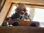 Goofy's Playhouse Filled with a bag of items in the back, and the rocket removed and painted green.