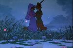 Maid Marian and Robin Hood together at night, next to a pond full of fireflies