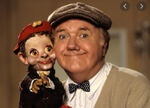 Chuck McCann holding a puppet.