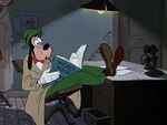 Goofy reading a Mickey Mouse comic book. (How to Be a Detective)