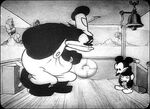 Pete scowling at Mickey Mouse in Steamboat Willie