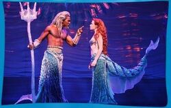 King Triton scolds Ariel.