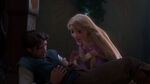 Rapunzel tries to heal Eugene.