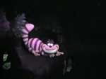 The second Cheshire Cat figure pointing the way to The Queen of Hearts' Castle. (This figure had several different glow-in-the-dark-paint-job updates through the years; this variant was used during the 80s and 90s)