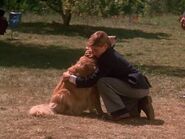 Peter lovingly hugging Shadow after playing basketball with him