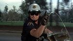 Officer Carmody signaling to the Garrisons to pull over