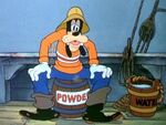 Goofy sitting on barrel of powder