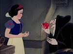 The Queen offering the poisoned apple to Snow White.