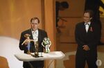 John Lasseter accepting his Oscar for Toy Story at the 68th Academy Awards as Robin Williams watches.