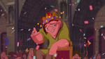 Quasimodo waving at his master Claude Frollo, who is furious at him for sneaking into the festival