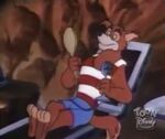 Don Karnage in his beach outfit, looking at himself in a mirror and talking to Louie