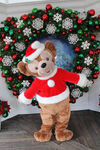 Duffy the Disney Bear posing for a photo near Treasures in Paradise at Paradise Pier at Disney California Adventure in his Christmas outfit.