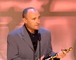 Collins accepting the award for Best Original Song for "You'll Be in the Heart."