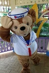 Duffy posing for a photo in the Fantasy Gardens at Hong Kong Disneyland.