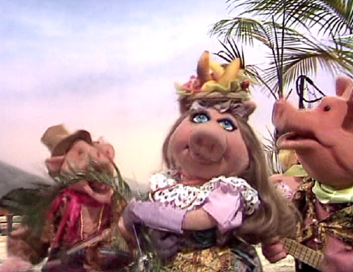 The number is performed by Miss Piggy, Kermit, and the pigs (including Anni...