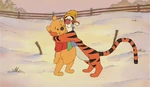 Winnie the Pooh is being hugged by Tigger