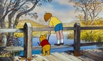 Christopher Robin and Pooh Bear are both on a bridge