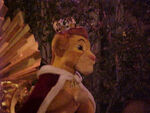 Simba in a king's outfit in Disneyland's "Parade of the Stars"