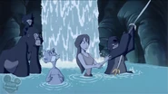 Jane and Professor Porter using their shirts to make a rope to escape from the flooded cave