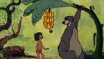 Baloo offers Mowgli a banana.