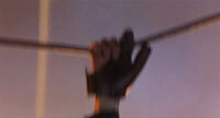 Strasser hanging by his severed right hand