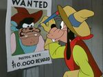 Goofy drawing a mustache on Pete's wanted sign