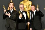 Clark Spencer, Byron Howard, and Rich Moore pose in the press room during the 89th annual Academy Awards in February 2017.