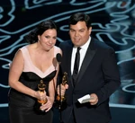 Robert and Kristen Anderson-Lopez speak onstage at the 84th annual Academy Awards in February 2014.