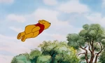 Winnie the Pooh is flying through the air