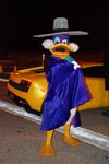 Darkwing Duck posing in front of a Lamborghini Exotic Driving Experience at the Walt Disney World Speedway.