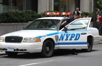 A New York City Police Department officer exits his patrol cruiser