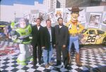 Tim Allen with John Lasseter and Tom Hanks, along with Buzz (left) and Woody (right).
