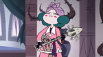 Eclipsa playing a skeleton guitar